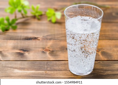 Carbonated water on wood grain background