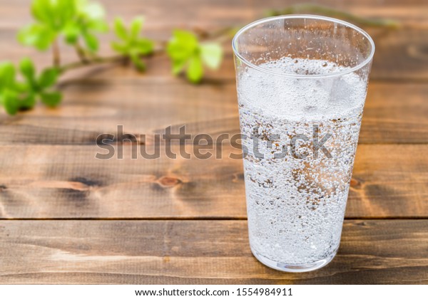 Carbonated water on wood\
grain background