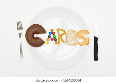 Carbs Word On A Plate Made Of Real Food, Shot From Above, White Background, No Retouch. Keto Diet And LCHF Concept