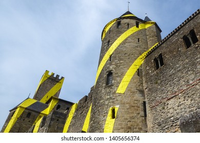 CARCASSONNE, FRANCE - 07-28-2018: Installation art by italian artist Felice Varini in the Castle of Carcassonne. Fortified medieval city, UNESCO. Yellow circles.