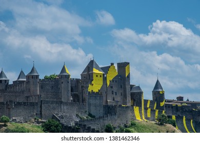 Carcassonne, France - June 29 2018:Designed by Felice Varini,Thin, painted aluminium sheets on the walls and towers,a succession of yellow 'eccentric concentric circles.