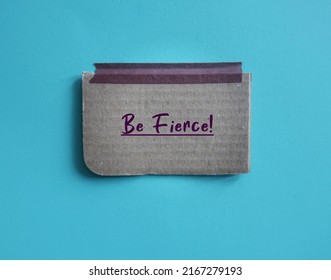 Card Box Paper Stick On Blue Background With Handwritten Text BE FIERCE!, Concept Of Affirmation To Build Self Confidence, Furiously Active Or Determined - Bold Strong Cool Outstanding Woman