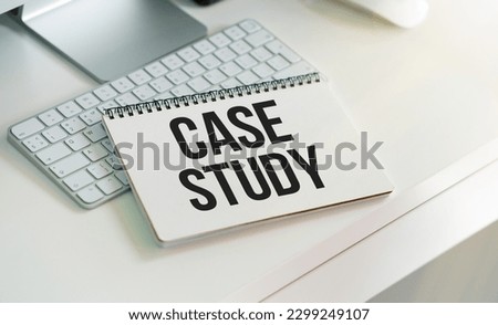 Card with case study text on a white background with office items. Business concept.