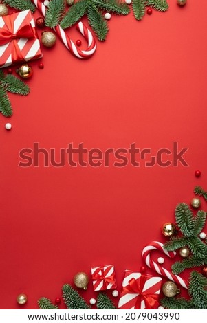 Card with Christmas frame for text with fir decorations and gifts on red background
