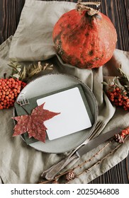 Card Mockup On Autumn Thanksgiving Dinner Table Setting With Pumpkins, Fallen Leaves And Vintage Cutlery Top View. Copy Space.Toned. Rustic Autumn Traditional Seasonal Table Setting At Home.