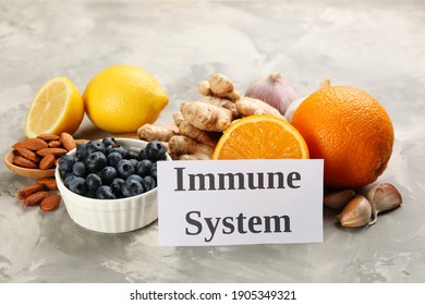 Card with phrase Immune System and fresh products on light marble background - Shutterstock ID 1905349321