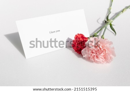 Card with pink and red carnations and love messages.