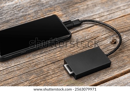 The card reader is connected to a mobile device: phone or tablet.