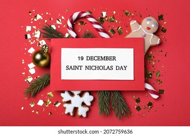 Card with text 19 December Saint Nicholas Day and festive decor on red background, flat lay - Powered by Shutterstock