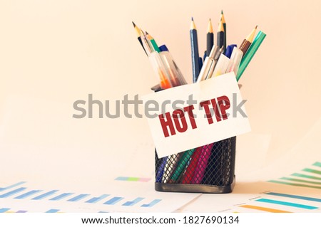 Card with text HOT TIP on the pen box in the office. Diagram and white background