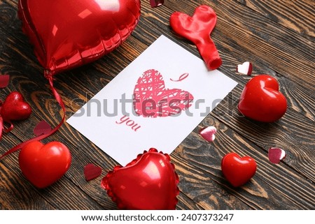 Card with text I LOVE YOU, heart shaped balloons and decor on wooden background. Valentines Day celebration