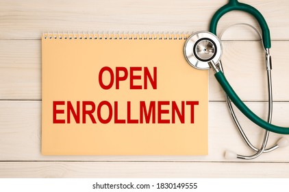 Card with text OPEN ENROLLMENT and stethoscope, medical concept.