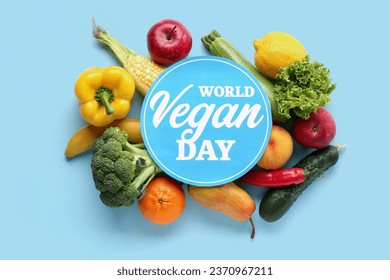 Card with text WORLD VEGAN DAY, fresh vegetables and fruits on blue background - Powered by Shutterstock