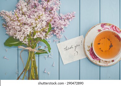 card thank you, summer bouquet of beautiful blooming lilac and english black tea in china teacup with saucer