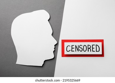 Card with word Censored and man's head cutout on color background, flat lay