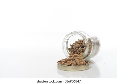 Cardamom In Glass Container Over White Background