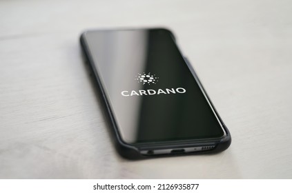 Cardano ADA Symbol On The Phone Display At The Office