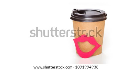 Cardboard beaker for hot drinks with a red lips. Concept for female day. One cup of coffee.