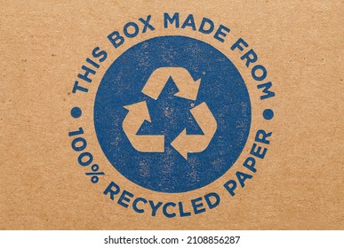 Cardboard Box with Blue Recycle Symbol Background.