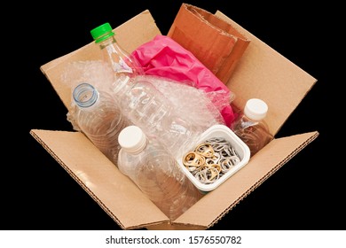 Cardboard Box Or Carton Filled With Plastic Bottle , Plastic Bag ,waste Paper ,ring Pull Or Pull Tab , On Black Background  Wait For Reuse Or Recycle , Save Environment And Green Concept 