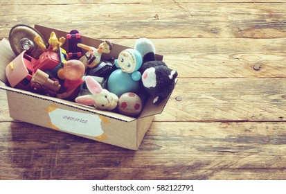 Cardboard Box With Old Dusty Toys, Glued Note With The Word 