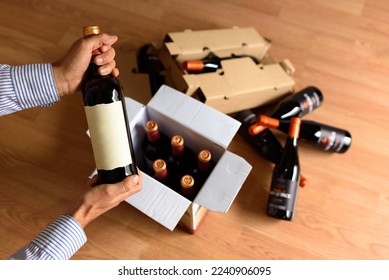 Cardboard box with quality wine bottles sent by post - Shutterstock ID 2240906095