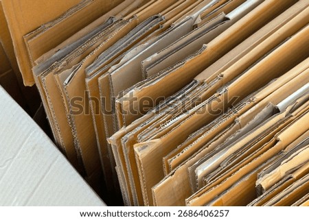 cardboard box, stack of folded corrugated cardboard boxes neatly arranged, brown packaging carton box, representing recycling, packaging, eco, and sustainable resource use