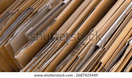 cardboard box, stack of folded corrugated cardboard boxes neatly arranged, brown packaging carton box, representing recycling, packaging, eco, and sustainable resource use