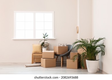 Cardboard Boxes With Belongings In New Flat On Moving Day