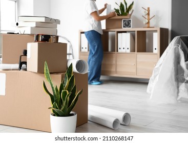 Cardboard Boxes With Belongings In Office On Moving Day