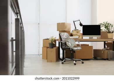 Cardboard Boxes, Computer And Furniture In New Office. Moving Day