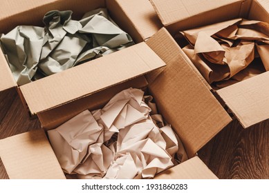 Cardboard boxes with crumpled paper inside for packaging goods from online stores, eco friendly packaging made of recyclable raw materials - Shutterstock ID 1931860283
