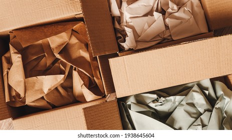 Cardboard boxes with crumpled paper inside for packaging goods from online stores, eco friendly packaging made of recyclable raw materials - Shutterstock ID 1938645604