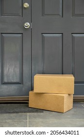 cardboard boxes delivered to the forn door and left outside for contactless pickup, delivery for online shopping, contact-free delivery and pickup due to COVID-19. High quality photo - Shutterstock ID 2056434011