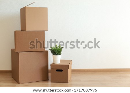Cardboard boxes in empty room, movement concept. No people