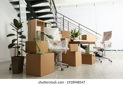 Cardboard Boxes And Furniture Near Stairs In Office. Moving Day