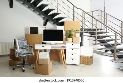 Cardboard Boxes And Furniture Near Stairs In Office. Moving Day