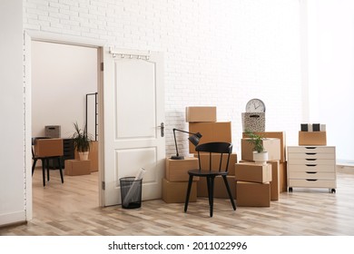 Cardboard Boxes And Furniture In New Office. Moving Day