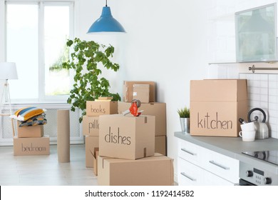 Cardboard boxes and household stuff indoors. Moving day - Shutterstock ID 1192414582