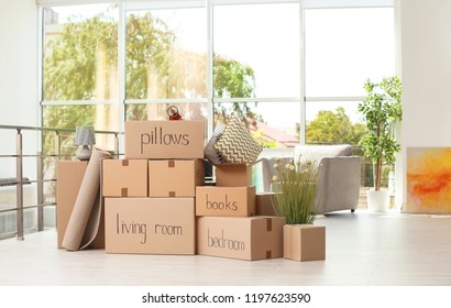Cardboard boxes and household stuff indoors. Moving day - Shutterstock ID 1197623590