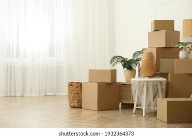 Cardboard boxes and household stuff indoors, space for text. Moving day - Shutterstock ID 1932364373
