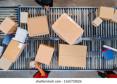 Cardboard Boxes Moving On Conveyor Belt In Warehouse.