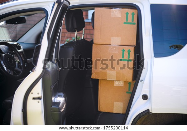 Cardboard Boxes on the\
back seat of a car.