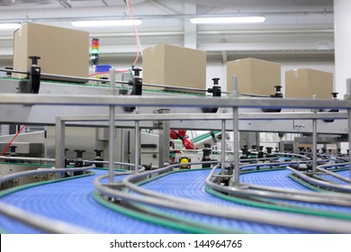  Cardboard boxes on conveyor belt in factory  - Powered by Shutterstock