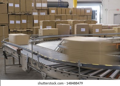 Cardboard Boxes On Conveyor Belt In Distribution Warehouse