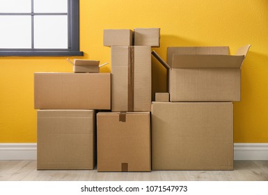 Cardboard boxes on floor indoors - Shutterstock ID 1071547973