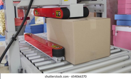 Cardboard Boxes On A Transporter Of A Packaging Line