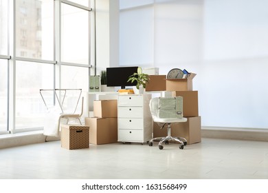 Cardboard Boxes And Packed Belongings In Office. Moving Day