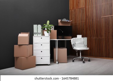 Cardboard Boxes And Packed Belongings In Office. Moving Day