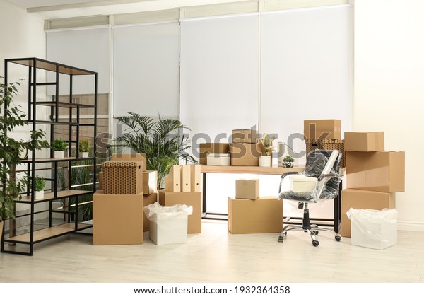 Cardboard
boxes and packed chair in office. Moving
day